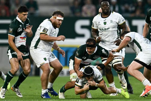 Pau's French flanker Loïc Credoz (Top) tackles Montauban's French scrum-half Mael Castel during the French Top14 rugby union match between Section Paloise Bearn Pyrenees (Pau) and US Montauban at Stade du Hameau in Pau, south-western France on June 6, 2026. (Photo by Philippe LOPEZ / AFP)