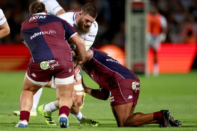 Clermont's Argentine lock Marcos Kremer (C) is tackled as he runs with the ball during the French Top14 rugby union match between Union Bordeaux-Begles (UBB) and ASM Clermont Auvergne at the Chaban-Delmas Stadium in Bordeaux, south-western France on June 6, 2026. (Photo by ROMAIN PERROCHEAU / AFP)
