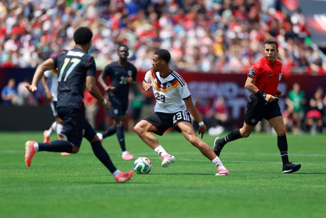 Germany's Felix Nmencha (C) vies with Malik Tillman of the US during the international friendly football match between USA and Germany at Soldier Field in Chicago, Illinois, on June 6, 2026. (Photo by KAMIL KRZACZYNSKI / AFP)