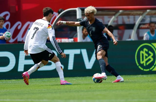 Germany's Kai Haavertz (L) challenges Antonee Robinson of the USduring the international friendly football match between USA and Germany at Soldier Field in Chicago, Illinois on June 6, 2026. (Photo by KAMIL KRZACZYNSKI / AFP)