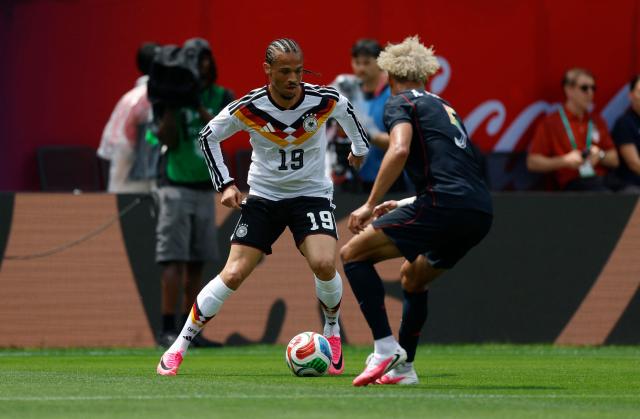 Germany's Leroy Sane is challenged by Antonee Robinson of the US during the international friendly football match between USA and Germany at Soldier Field in Chicago, Illinois, on June 6, 2026. (Photo by KAMIL KRZACZYNSKI / AFP)