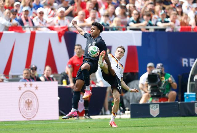 Germany's Florian Wirtz (R) vies for the ball Weston McKennie of the US during the international friendly football match between USA and Germany at Soldier Field in Chicago, Illinois on June 6, 2026. (Photo by KAMIL KRZACZYNSKI / AFP)