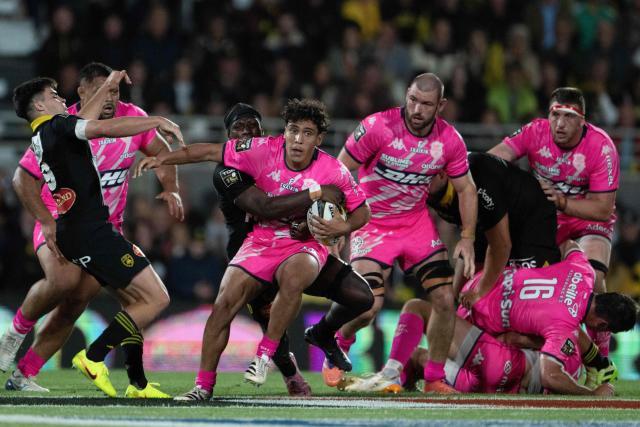 Stade Français' French scrum-half Thibaut Motassi is tackled as he runs with the ball during the French Top14 rugby union match between Stade Rochelais (La Rochelle) and Stade Francais Paris at The Marcel-Deflandre Stadium in La Rochelle, western France on June 6, 2026. (Photo by XAVIER LEOTY / AFP)