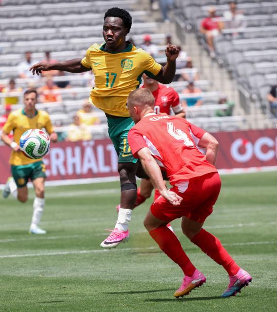 Australia's Nestory Irankunda (C) and Switzerland's Nico Elvedi battle for the ball during the international friendly football match between Switzerland and Australia at Snapdragon Stadium in San Diego, California, on June 6, 2026. (Photo by SANDY HUFFAKER / AFP)