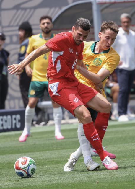 Australia's Awer Mabil (R) and Switzerland's Remo Freuler battle for the ball during the international friendly football match between Switzerland and Australia at Snapdragon Stadium in San Diego, California, on June 6, 2026. (Photo by SANDY HUFFAKER / AFP)