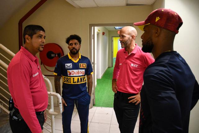Umpires Allahuddien Paleker (L) and Christopher Taylor (3L) talk to Kusal Mendis (2L) of Sri Lanka and Shai Hope (R) of West Indies about abandoning the second One Day International (ODI) cricket match between West Indies and Sri Lanka due to the rain at Sabina Park in Kingston, Jamaica, on June 6, 2026. (Photo by Randy Brooks / AFP)