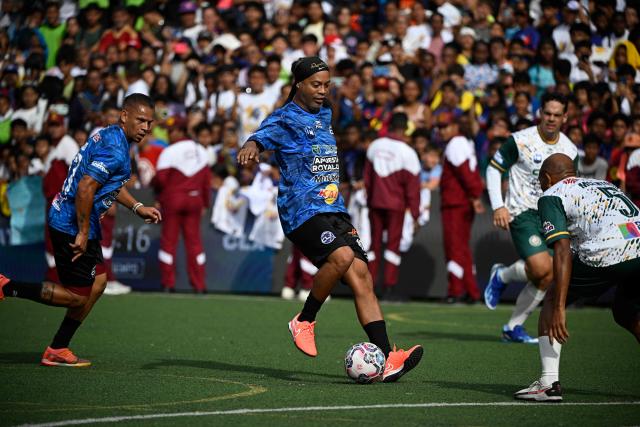 Brazilian former football star Ronaldinho controls the ball during the Monumental League exhibition football match between CLX Futbol and Patacones FC at the Mesuca community in the Petare neighborhood in Caracas on June 6, 2026. (Photo by Federico PARRA / AFP)