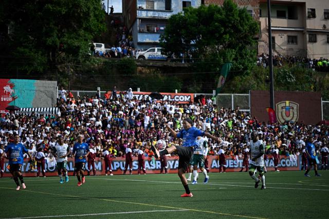 Brazilian former football star Ronaldinho controls the ball during the Monumental League exhibition football match between CLX Futbol and Patacones FC at the Mesuca community in the Petare neighborhood in Caracas on June 6, 2026. (Photo by Federico PARRA / AFP)