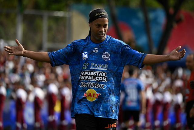 Brazilian former football star Ronaldinho gestures during the Monumental League exhibition football match between CLX Futbol and Patacones FC at the Mesuca community in the Petare neighborhood in Caracas on June 6, 2026. (Photo by Federico PARRA / AFP)