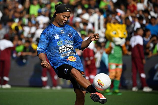 Brazilian former football star Ronaldinho controls the ball during the Monumental League exhibition football match between CLX Futbol and Patacones FC at the Mesuca community in the Petare neighborhood in Caracas on June 6, 2026. (Photo by Federico PARRA / AFP)