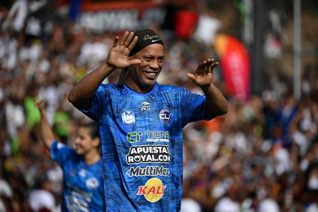 Brazilian former football star Ronaldinho gestures during the Monumental League exhibition football match between CLX Futbol and Patacones FC at the Mesuca community in the Petare neighborhood in Caracas on June 6, 2026. (Photo by Federico PARRA / AFP)