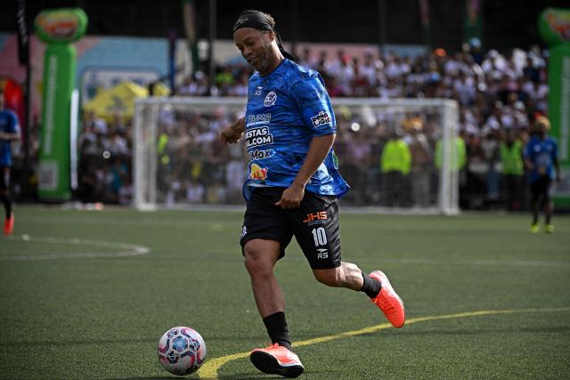 Brazilian former football star Ronaldinho controls the ball during the Monumental League exhibition football match between CLX Futbol and Patacones FC at the Mesuca community in the Petare neighborhood in Caracas on June 6, 2026. (Photo by Federico PARRA / AFP)