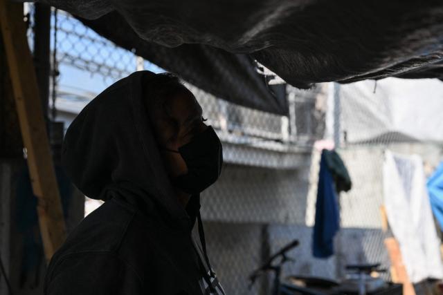 Maggie, who currently lives in an encampment and is on a waiting list for housing, speaks during an interview about working with an outreach team with Hope The Mission as they visit a homeless encampment in the Panorama City neighborhood of Los Angeles, California on June 1, 2026. Los Angeles, the second-largest US city prepares to host eight World Cup soccer matches this summer, followed by the 2028 Olympics. Infamous for its squalid encampments—located right on the sidewalks or beneath massive highway overpasses—the "City of Angels" has been pulling out all the stops over the past three years to house its homeless population. Democratic Mayor Karen Bass has made this a top priority, ramping up initiatives to fund thousands of housing spots, whether in hotels or in "tiny homes" (Photo by Patrick T. Fallon / AFP)