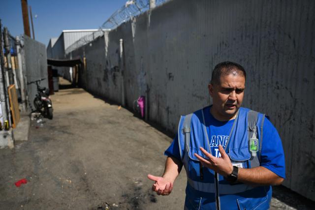 Outreach worker Armando Covarrubias of Hope The Mission speaks about waitlists for housing near a homeless encampment in the Panorama City neighborhood of Los Angeles, California on June 1, 2026. Los Angeles, the second-largest US city prepares to host eight World Cup soccer matches this summer, followed by the 2028 Olympics. Infamous for its squalid encampments—located right on the sidewalks or beneath massive highway overpasses—the "City of Angels" has been pulling out all the stops over the past three years to house its homeless population. Democratic Mayor Karen Bass has made this a top priority, ramping up initiatives to fund thousands of housing spots, whether in hotels or in "tiny homes" (Photo by Patrick T. Fallon / AFP)