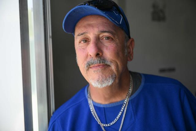 Michael Reyes stands for a portrait inside their interim housing in a Tiny Home Village of Pallet Shelters managed by Hope The Mission in the Eagle Rock neighborhood of Los Angeles, California on June 1, 2026. Los Angeles, the second-largest US city prepares to host eight World Cup soccer matches this summer, followed by the 2028 Olympics. Infamous for its squalid encampments—located right on the sidewalks or beneath massive highway overpasses—the "City of Angels" has been pulling out all the stops over the past three years to house its homeless population. Democratic Mayor Karen Bass has made this a top priority, ramping up initiatives to fund thousands of housing spots, whether in hotels or in "tiny homes" (Photo by Patrick T. Fallon / AFP)