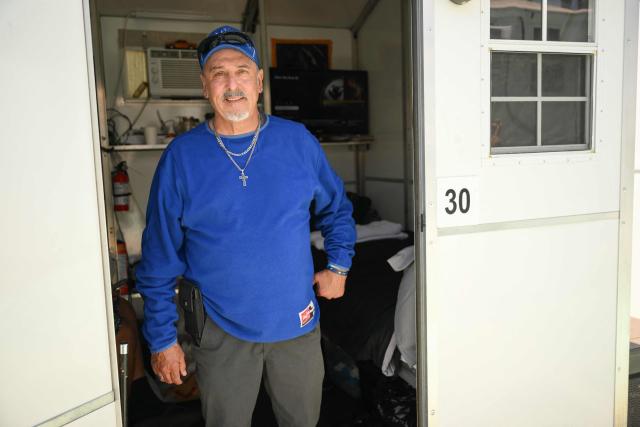 Michael Reyes stands for a portrait inside their interim housing in a Tiny Home Village of Pallet Shelters managed by Hope The Mission in the Eagle Rock neighborhood of Los Angeles, California on June 1, 2026. Los Angeles, the second-largest US city prepares to host eight World Cup soccer matches this summer, followed by the 2028 Olympics. Infamous for its squalid encampments—located right on the sidewalks or beneath massive highway overpasses—the "City of Angels" has been pulling out all the stops over the past three years to house its homeless population. Democratic Mayor Karen Bass has made this a top priority, ramping up initiatives to fund thousands of housing spots, whether in hotels or in "tiny homes" (Photo by Patrick T. Fallon / AFP)