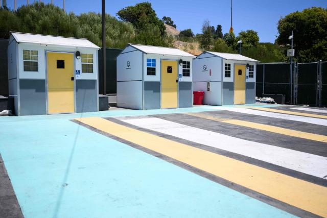 Pallet Shelters stand inside a Tiny Home Village managed by Hope The Mission for interim homeless housing in the Eagle Rock neighborhood of Los Angeles, California on June 1, 2026. Los Angeles, the second-largest US city prepares to host eight World Cup soccer matches this summer, followed by the 2028 Olympics. Infamous for its squalid encampments—located right on the sidewalks or beneath massive highway overpasses—the "City of Angels" has been pulling out all the stops over the past three years to house its homeless population. Democratic Mayor Karen Bass has made this a top priority, ramping up initiatives to fund thousands of housing spots, whether in hotels or in "tiny homes" (Photo by Patrick T. Fallon / AFP)
