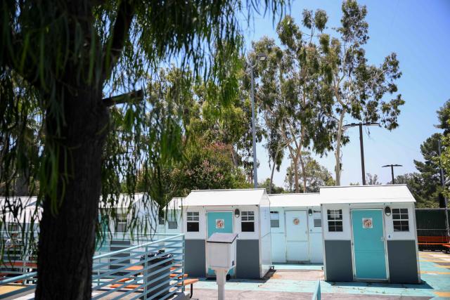 Pallet Shelters stand inside a Tiny Home Village managed by Hope The Mission for interim homeless housing in the Eagle Rock neighborhood of Los Angeles, California on June 1, 2026. Los Angeles, the second-largest US city prepares to host eight World Cup soccer matches this summer, followed by the 2028 Olympics. Infamous for its squalid encampments—located right on the sidewalks or beneath massive highway overpasses—the "City of Angels" has been pulling out all the stops over the past three years to house its homeless population. Democratic Mayor Karen Bass has made this a top priority, ramping up initiatives to fund thousands of housing spots, whether in hotels or in "tiny homes" (Photo by Patrick T. Fallon / AFP)