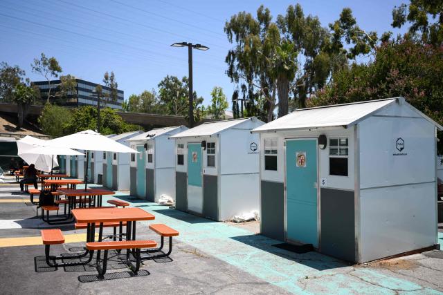 Pallet Shelters stand inside a Tiny Home Village managed by Hope The Mission for interim homeless housing in the Eagle Rock neighborhood of Los Angeles, California on June 1, 2026. Los Angeles, the second-largest US city prepares to host eight World Cup soccer matches this summer, followed by the 2028 Olympics. Infamous for its squalid encampments—located right on the sidewalks or beneath massive highway overpasses—the "City of Angels" has been pulling out all the stops over the past three years to house its homeless population. Democratic Mayor Karen Bass has made this a top priority, ramping up initiatives to fund thousands of housing spots, whether in hotels or in "tiny homes" (Photo by Patrick T. Fallon / AFP)