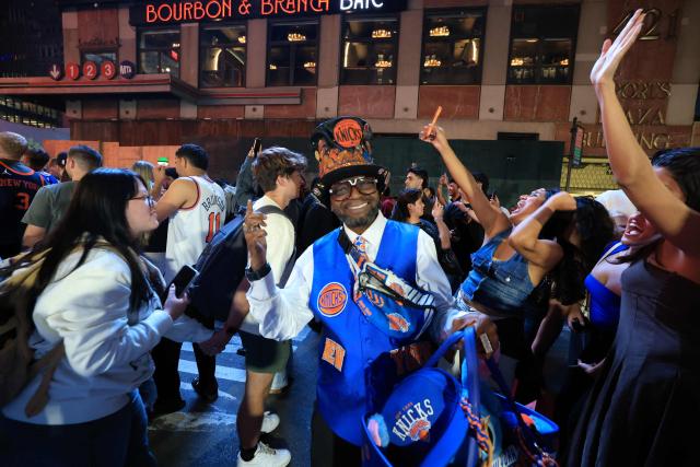 (FILES) Knicks fans celebrate in New York City after the New York Knicks defeated the San Antonio Spurs in Game 1 of the NBA Finals, on June 3, 2026. As New York prepares to host the World Cup, the city is instead awash in Knicks blue and orange, reflecting a deep love for the gritty, unifying team chasing a historic NBA Finals victory. The Knicks took a commanding 2-0 lead on June 5 in the best of seven series against the San Antonio Spurs, and now the action shifts to the Big Apple for games three and four. (Photo by TIMOTHY A.CLARY / AFP)