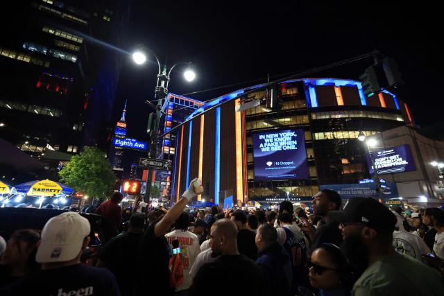 (FILES) Basketball fans gather outside Madison Square Garden during Game 1 of the NBA Finals between the New York Knicks and the San Antonio Spurs, in New York City, on June 3, 2026. As New York prepares to host the World Cup, the city is instead awash in Knicks blue and orange, reflecting a deep love for the gritty, unifying team chasing a historic NBA Finals victory. The Knicks took a commanding 2-0 lead on June 5 in the best of seven series against the San Antonio Spurs, and now the action shifts to the Big Apple for games three and four. (Photo by Timothy A. CLARY / AFP)