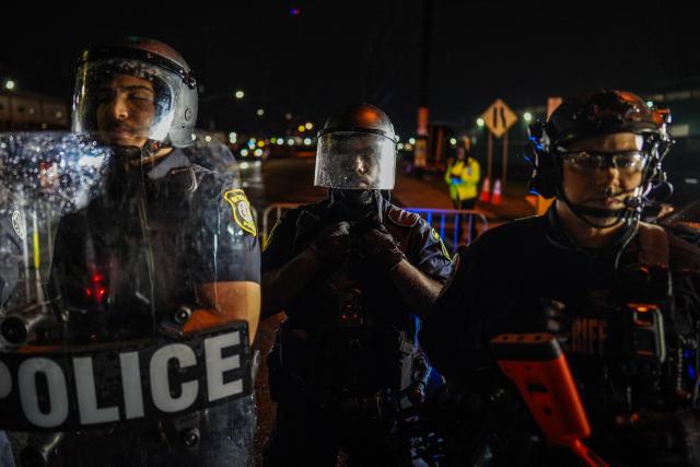 Newark police officers stand guard as protesters gather outside Delaney Hall, which is being used as an Immigration and Customs Enforcement (ICE) detention center, in Newark, New Jersey on June 6, 2026. The US state of New Jersey on June 2, 2026, sued the private prison company that runs the migrant detention center where protesters have rallied for several days over allegedly poor conditions at the jail. The lawsuit against GEO Group demands that local health authorities be allowed full access to Delaney Hall, one of many facilities holding people rounded up in US President Donald Trump's mass deportation sweep. (Photo by Ryan MURPHY / AFP)