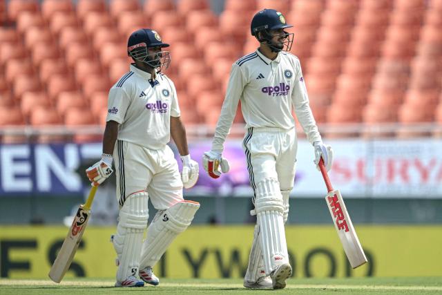 India's captain Shubman Gill (R) and teammate Rishabh Pant look on during the second day of the only Test cricket match between India and Afghanistan at the Maharaja Yadavindra Singh International Cricket Stadium on the outskirts of Chandigarh on June 7, 2026. (Photo by Shammi MEHRA / AFP)