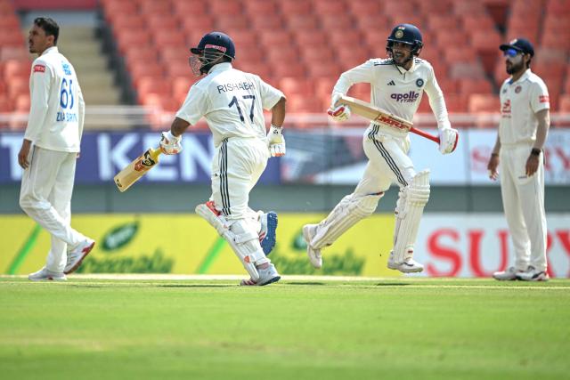 India's captain Shubman Gill (2R) and teammate Rishabh Pant (2L) run between the wickets during the second day of the only Test cricket match between India and Afghanistan at the Maharaja Yadavindra Singh International Cricket Stadium on the outskirts of Chandigarh on June 7, 2026. (Photo by Shammi MEHRA / AFP)