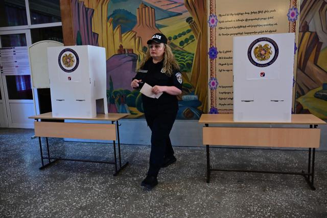 An Armenian police officer votes in the parliamentary election at a polling station in Yerevan on June 7, 2026. (Photo by Karen MINASYAN / AFP)