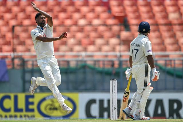 Afghanistan's Mohammad Saleem (L) bowls as India's Rishabh Pant watches during the second day of the only Test cricket match between India and Afghanistan at the Maharaja Yadavindra Singh International Cricket Stadium on the outskirts of Chandigarh on June 7, 2026. (Photo by Shammi MEHRA / AFP)