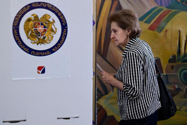 A woman votes in Armenia's parliamentary election at a polling station in Yerevan on June 7, 2026. (Photo by Karen MINASYAN / AFP)