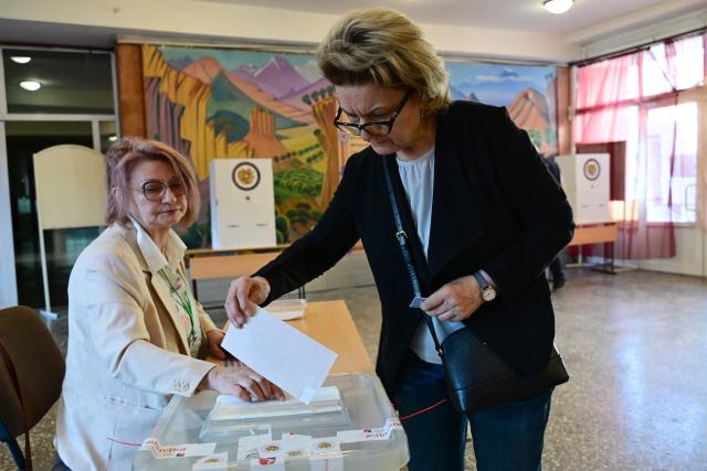 A woman casts her ballot in Armenia's parliamentary election at a polling station in Yerevan on June 7, 2026. (Photo by Karen MINASYAN / AFP)