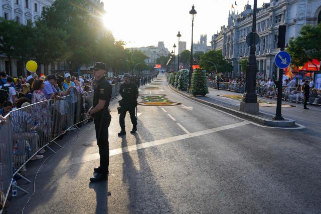 People wait for the start of the Holy Mass, to be led by Pope Leo XIV in the Plaza de Cibeles, in an adjacent street in Madrid on June 7, 2026. Pope Leo XIV is visiting Spain June 6-12 with stops in Madrid, Barcelona, and the Canary Islands, where he will meet with migrants and organisations dedicated to helping them. (Photo by Cesar MANSO / AFP)