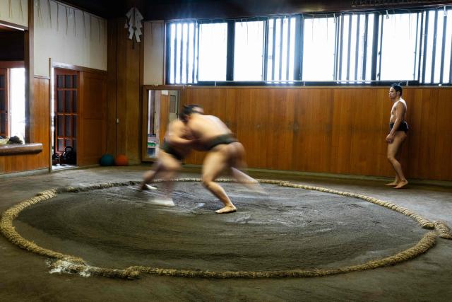 Sumo wrestlers train in the dohyo, a wrestling ring, at the Dewanoumi sumo stable in Tokyo on June 4, 2026. The stable, founded in 1862 and one of the sport's oldest, has become a major lineage in modern sumo, producing many top-division wrestlers. (Photo by Andrew CABALLERO-REYNOLDS / AFP)
