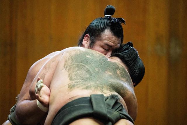 Sumo wrestlers train in the dohyo, a wrestling ring, at the Dewanoumi sumo stable in Tokyo on June 4, 2026. The stable, founded in 1862 and one of the sport's oldest, has become a major lineage in modern sumo, producing many top-division wrestlers. (Photo by Andrew CABALLERO-REYNOLDS / AFP)