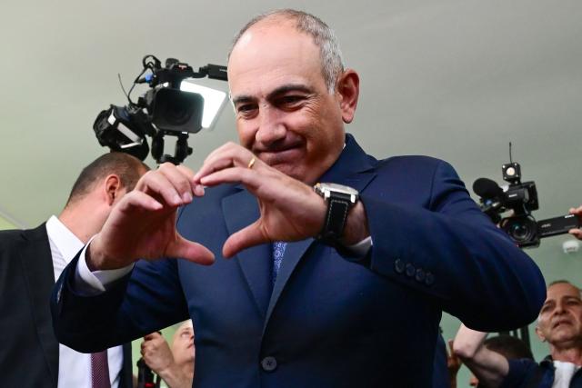 TOPSHOT - Armenian Prime Minister Nikol Pashinyan gestures a heart with his hands after casting his ballot in the parliamentary election at a polling station in Yerevan on June 7, 2026. (Photo by Karen MINASYAN / AFP)