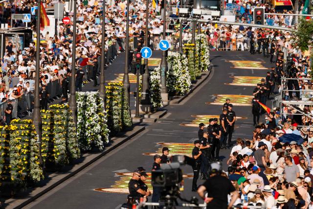 People gather as they await the start of the Holy Mass, to be led by Pope Leo XIV in the Plaza de Cibeles, in Madrid on June 7, 2026. Pope Leo XIV is visiting Spain June 6-12 with stops in Madrid, Barcelona, and the Canary Islands, where he will meet with migrants and organisations dedicated to helping them. (Photo by Oscar DEL POZO / AFP)