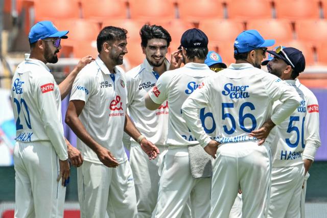 Afghanistan's Mohammad Saleem (2L) celebrates with teammates after taking a five-wicket haul during the second day of the only Test cricket match between India and Afghanistan at the Maharaja Yadavindra Singh International Cricket Stadium on the outskirts of Chandigarh on June 7, 2026. (Photo by Shammi MEHRA / AFP)