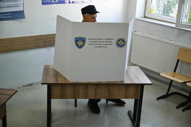 A man prepares before casting his ballot at a polling station on the day of general elections in Pristina on June 7, 2026. Polls opened on June 7, 2026 for another snap election in Kosovo, its third in just over a year, as voter frustration mounts at a grinding political gridlock in Europe's youngest country, as the ballot comes after a polarised parliament failed to elect a president in April, deepening a political crisis that has gripped the country since inconclusive parliamentary elections in February 2025. (Photo by Armend NIMANI / AFP)