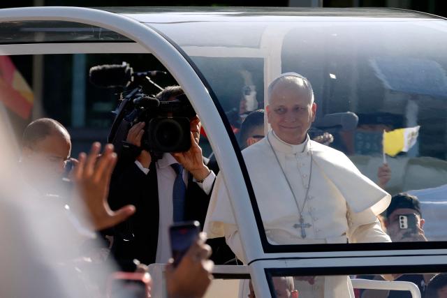 Pope Leo XIV smiles from the popemobile as he arrives to lead the Holy Mass in the Plaza de Cibeles in Madrid on June 7, 2026. Pope Leo XIV is visiting Spain June 6-12 with stops in Madrid, Barcelona, and the Canary Islands, where he will meet with migrants and organisations dedicated to helping them. (Photo by Oscar DEL POZO / AFP)