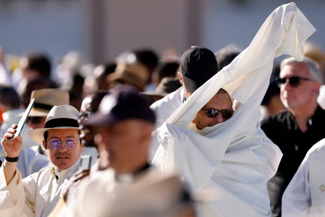 A priest puts on his religious habit before the Holy Mass to be led by Pope Leo XIV in the Plaza de Cibeles in Madrid on June 7, 2026. Pope Leo XIV is visiting Spain June 6-12 with stops in Madrid, Barcelona, and the Canary Islands, where he will meet with migrants and organisations dedicated to helping them. (Photo by Oscar DEL POZO / AFP)