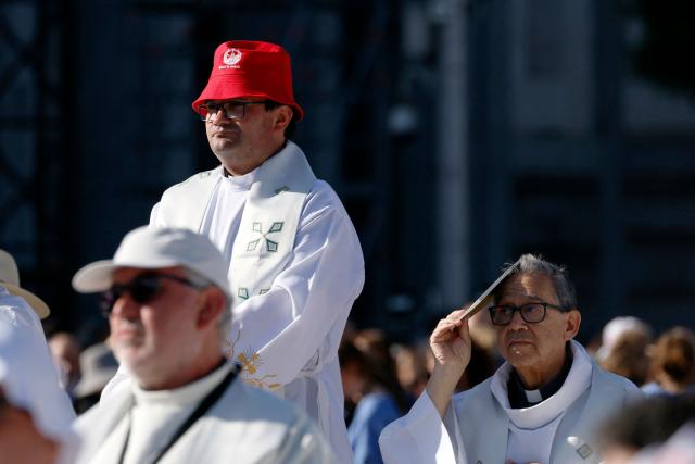 Priests await the start of the Holy Mass led by Pope Leo XIV in the Plaza de Cibeles in Madrid on June 7, 2026. Pope Leo XIV is visiting Spain June 6-12 with stops in Madrid, Barcelona, and the Canary Islands, where he will meet with migrants and organisations dedicated to helping them. (Photo by Oscar DEL POZO / AFP)