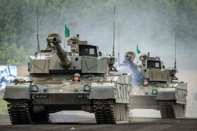 Type 90 battle tanks of the Japan Ground Self-Defense Force (JGSDF) are seen during a live fire exercise at East Fuji Maneuver Area in Gotemba on June 7, 2026. (Photo by Yuichi YAMAZAKI / AFP)