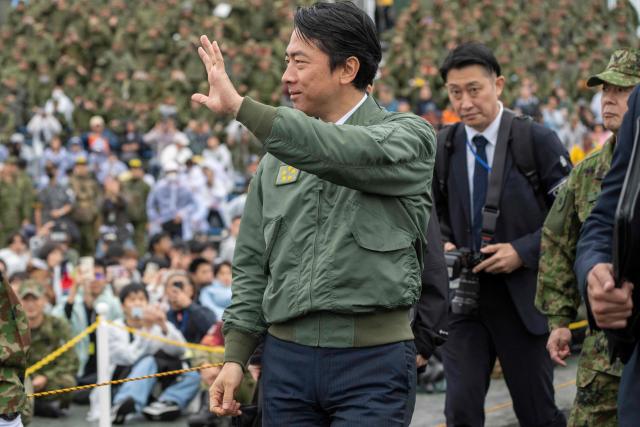 Japan’s Defence Minister Shinjiro Koizumi waves as he leaves a live fire exercise at East Fuji Maneuver Area in Gotemba on June 7, 2026. (Photo by Yuichi YAMAZAKI / AFP)