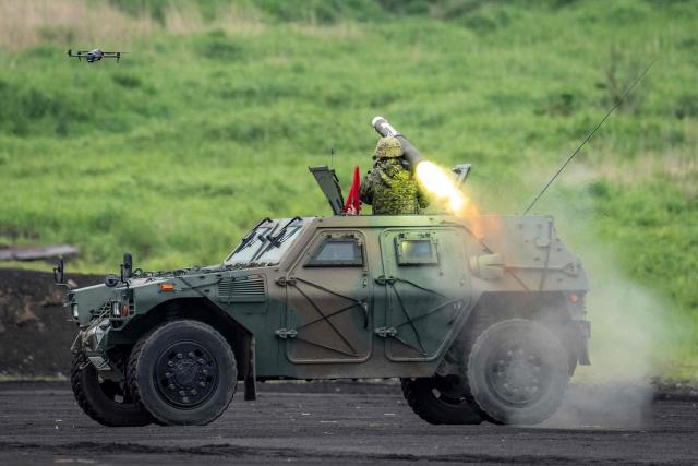 A soldier fires an anti-tank weapon from an armoured vehicle of the Japan Ground Self-Defense Force (JGSDF) during a live fire exercise at East Fuji Maneuver Area in Gotemba on June 7, 2026. (Photo by Yuichi YAMAZAKI / AFP)
