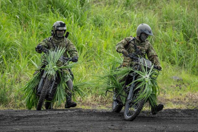 Japan Ground Self-Defense Force (JGSDF) soldiers ride motorcycle during a live fire exercise at East Fuji Maneuver Area in Gotemba on June 7, 2026. (Photo by Yuichi YAMAZAKI / AFP)