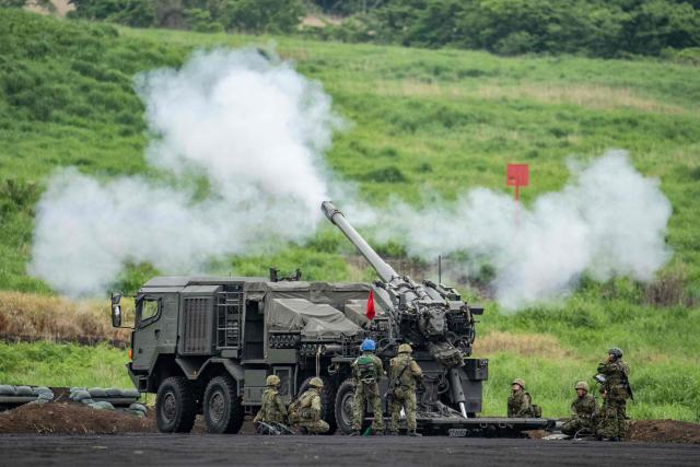 Artillery is fired from an armoured vehicle of the Japan Ground Self-Defense Force (JGSDF) during a live fire exercise at East Fuji Maneuver Area in Gotemba on June 7, 2026. (Photo by Yuichi YAMAZAKI / AFP)