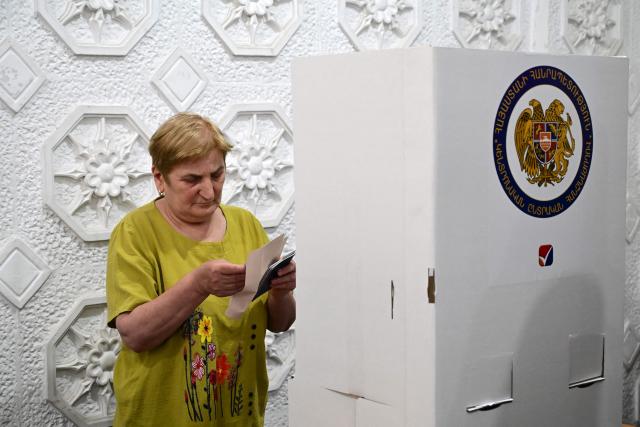 A woman votes in Armenia's parliamentary election at a polling station in Yerevan on June 7, 2026. (Photo by Karen MINASYAN / AFP)
