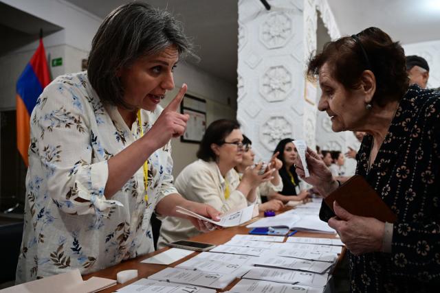 Armenians vote in the parliamentary election at a polling station in Yerevan on June 7, 2026. (Photo by Karen MINASYAN / AFP)
