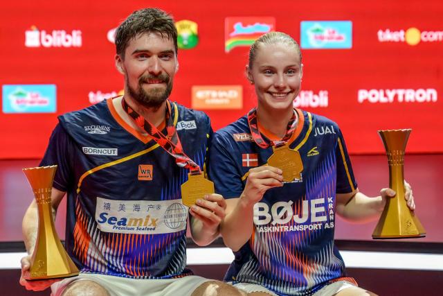 Denmark's Mathias Christiansen and Alexandra Boje pose during the medal ceremony after winning their mixed doubles final match against China's Cheng Xing and Zhang Chi at the Indonesia Open badminton tournament in Jakarta on June 7, 2026. (Photo by BAY ISMOYO / AFP)